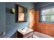 Bathroom features a bathtub with tiled walls, a window, and a vanity with a sink at 1388 Metropolitan Se Ave, Atlanta, GA 30316