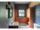 Bathroom features a bathtub with tiled walls, a window, and a vanity with a sink at 1388 Metropolitan Se Ave, Atlanta, GA 30316