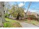 Quaint home with driveway, mature trees, and blossoming bushes in the yard at 1388 Metropolitan Se Ave, Atlanta, GA 30316