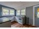 Compact kitchen featuring white cabinets, granite countertops, and wood-look flooring at 1388 Metropolitan Se Ave, Atlanta, GA 30316