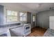 Compact kitchen features white cabinets, granite countertops, vintage stove, and exterior door at 1388 Metropolitan Se Ave, Atlanta, GA 30316