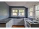 Compact kitchen featuring white cabinets, granite countertops, and an adjacent vintage stove at 1388 Metropolitan Se Ave, Atlanta, GA 30316