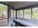 Enclosed porch area with multiple windows, a built-in bench and views of the property at 1388 Metropolitan Se Ave, Atlanta, GA 30316