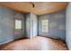 Room featuring a cloud motif, a vintage ceiling, worn floors, and natural light from the window at 1388 Metropolitan Se Ave, Atlanta, GA 30316