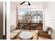 Covered balcony showcasing comfortable seating, ceiling fan, and a view of the neighboring townhome community at 423 Burton Dr, Alpharetta, GA 30009