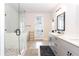 Bright bathroom featuring double vanity, glass shower with white herringbone tile and free standing tub at 423 Burton Dr, Alpharetta, GA 30009