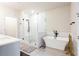 Bright bathroom with a soaking tub, glass shower, and modern fixtures at 423 Burton Dr, Alpharetta, GA 30009