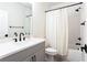 Bathroom features a white shower curtain, modern black hardware, and gray vanity at 423 Burton Dr, Alpharetta, GA 30009