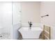 Modern bathroom featuring a freestanding tub, glass shower with white herringbone tile and black fixtures at 423 Burton Dr, Alpharetta, GA 30009