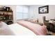 Bedroom features neutral tones, comfortable bed, modern art and desk with a computer at 423 Burton Dr, Alpharetta, GA 30009