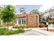 Community clubhouse featuring brick exterior, manicured landscaping, and a pool area with accessible parking at 423 Burton Dr, Alpharetta, GA 30009