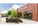 Storefront of The Happy Home in a red brick building with large display windows and outdoor seating area at 423 Burton Dr, Alpharetta, GA 30009