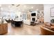 Expansive living area with a fireplace, built-in shelves, and modern kitchen access at 423 Burton Dr, Alpharetta, GA 30009