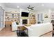 Cozy living room with fireplace, built-in shelves, and a ceiling fan at 423 Burton Dr, Alpharetta, GA 30009