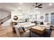 Open-concept living room with hardwood floors, modern furnishings, and access to the kitchen at 423 Burton Dr, Alpharetta, GA 30009
