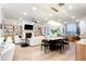 Open living space featuring hardwood floors, modern fireplace, dining area, and a kitchen island at 423 Burton Dr, Alpharetta, GA 30009