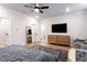Main bedroom with hardwood floors, full-length mirror, and access to the bathroom at 423 Burton Dr, Alpharetta, GA 30009
