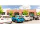 View of the parking lot in front of brick storefronts, including Blush Salon and BodyBar Pilates at 423 Burton Dr, Alpharetta, GA 30009