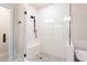 Modern shower features white herringbone tile, a glass door, black fixtures, and mosaic tile flooring at 423 Burton Dr, Alpharetta, GA 30009