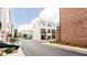 Street view showcases modern townhome exteriors, a paved street with sidewalks, and well maintained landscaping at 423 Burton Dr, Alpharetta, GA 30009