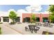Outdoor town square featuring picnic tables and storefronts with brick facades and lush green landscaping at 423 Burton Dr, Alpharetta, GA 30009