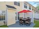 Backyard patio with outdoor table, chairs, and red umbrella offers a cozy space at 6918 Gallant Se Cir # 22, Mableton, GA 30126