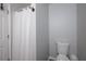 Clean bathroom with a white shower curtain, toilet, and fresh neutral decor, providing a functional space at 6918 Gallant Se Cir # 22, Mableton, GA 30126