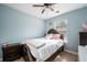 Comfortable bedroom with a bed, ceiling fan, and bright window at 6918 Gallant Se Cir # 22, Mableton, GA 30126