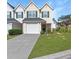 Attractive townhome featuring a one-car garage, driveway, and green lawn at 6918 Gallant Se Cir # 22, Mableton, GA 30126
