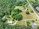 Aerial view highlights a house with a generous yard and mature tree cover at 743 New Hope Rd, Lawrenceville, GA 30046