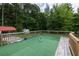 Backyard deck with artificial turf, wood railing, and a fire pit at 743 New Hope Rd, Lawrenceville, GA 30046