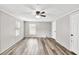 Neutral bedroom with wood-look floors, a ceiling fan and natural light from the window at 743 New Hope Rd, Lawrenceville, GA 30046