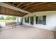Open air, covered deck features a hanging porch swing and access to the home at 743 New Hope Rd, Lawrenceville, GA 30046