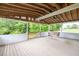 Covered deck with exposed rafters, a ceiling fan and a porch swing at 743 New Hope Rd, Lawrenceville, GA 30046