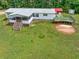Aerial view of home with a covered patio, additional wooden deck, mature trees, and a large green lawn at 743 New Hope Rd, Lawrenceville, GA 30046