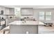Modern kitchen boasts stainless steel appliances, countertops, large windows, and a center island with seating at 743 New Hope Rd, Lawrenceville, GA 30046