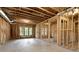 Unfinished basement featuring wood framing, concrete floor, and window views to the yard at 385 Windy Pines Trl, Roswell, GA 30075