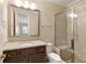 Modern bathroom features a granite vanity, framed mirror, glass enclosed shower, and tiled flooring at 385 Windy Pines Trl, Roswell, GA 30075