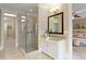 Bright bathroom featuring a glass shower, granite vanity, and a view into the adjacent bedroom at 385 Windy Pines Trl, Roswell, GA 30075