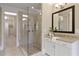 Bright bathroom featuring a glass shower, granite vanity, and a view into the adjacent bedroom at 385 Windy Pines Trl, Roswell, GA 30075