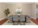 Formal dining room with modern chandelier, table, seating, and artwork at 385 Windy Pines Trl, Roswell, GA 30075