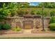 A serene garden with brick walls, stone pathways, and ample seating at 385 Windy Pines Trl, Roswell, GA 30075