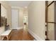 Elegant hallway featuring hardwood floors, neutral walls, crown molding, and a stylish bench near the front door at 385 Windy Pines Trl, Roswell, GA 30075