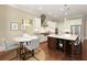 Stylish kitchen with island seating, stainless appliances, and modern lighting at 385 Windy Pines Trl, Roswell, GA 30075
