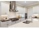 Modern kitchen with stainless appliances, gas range, and quartz countertops at 385 Windy Pines Trl, Roswell, GA 30075