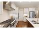 Modern kitchen with stainless steel appliances, white cabinetry, and dark countertops at 385 Windy Pines Trl, Roswell, GA 30075