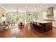 Bright open-concept living area features hardwood floors, a modern kitchen island, and lots of natural light at 385 Windy Pines Trl, Roswell, GA 30075