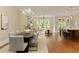 Spacious open-concept living area featuring hardwood floors, ample natural light, and seamless flow to kitchen at 385 Windy Pines Trl, Roswell, GA 30075