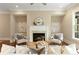 Inviting living room with cozy fireplace, comfortable seating, and stylish decor at 385 Windy Pines Trl, Roswell, GA 30075