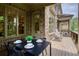 Covered porch with outdoor dining set and rocking chairs at 385 Windy Pines Trl, Roswell, GA 30075